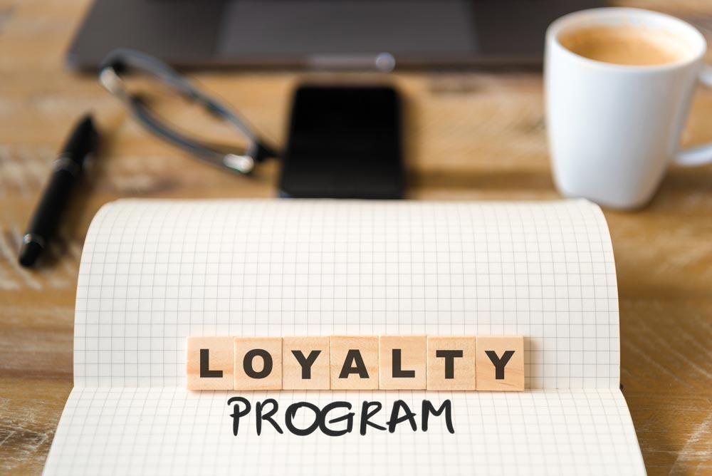 front focus on wooden blocks with letters making Loyalty Program text
