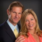 Smiling couple posing in formal attire.